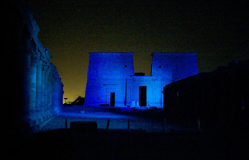 Philae Light Show EG052873JHP 
 Philae Temple Blue Light Show First Courtyard Colonnades Dark Night-time Aswan in which, during the first section, spectators walk through the temple with areas highlighted at each stop but the time to take photographs is limited. The second part of the evening is seated and photography is very easy, a tripod is permitted and necessary for time exposures to be made as flash on cameras is almost pointless and more of a nuisance for other viewers. This Sound & Light Show is perhaps the most spiritual of those shown at other centres especially with the trip at night by boat to the island and the peacefulness that naturally surrounds this location. 
 Keywords: Egypt, Egyptian, Aswan, River Nile, Agilkia Island, island, Philae, temple, light, sound, show, pylon, landscape, colonnades, court, entrance, Son, Lumiere, spectacular, fantasy, dramatic, night, dark, stars, blue, colours, colors, colourful, colorful, spiritual, surreal