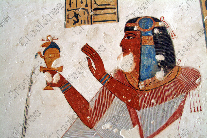 Valley Kings EG0213054jhp 
 Egyptian Tomb Prince Mentuherkhepshef painting closeup offering colourful was son of Ramasses 1X, but his tomb was unfinished but has some excellent colourful depictions of the important ancient Egyptian Gods and although protected by Perspex panels, the custodian was very helpful and slid them back for me to take photographs in 2002 when it was still allowed. Thanks to the capability of the modern digital camera, the first and only chance I have had to use one, a Fuji S2 as photography is now banned in the Valley of Kings per se and especially in the tombs. Adjustments in Photoshop give the chance of reasonably accurate colours even when the tomb paintings were lit by low level artificial light when tripods and flash were not allowed; what could I get with a Nikon F700 and a tripod, which were allowed at one time as well. 
 Keywords: Egypt, Luxor, West Bank, Thebes, Theban, Valley Kings, prince, tomb, KV19, Montu, Mentuherkhepshef, Montu-hir-Khopshef, landscape, paintings, colourful, colorful, colours, colors, bright, white, plaster, ancient, Egyptian, archaeology, Egyptology, hieroglyphs, death, burial, mythology, afterlife, history, hieroglyphics, Gods, offering, fruit, flowers, wine, grapes, bread, DSLR, Fuji, S2, handheld, artificial, light, Photoshop, adjusted, corrections, Perspex, screens