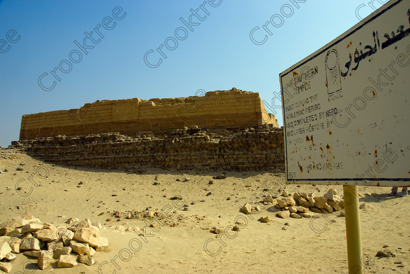 Karanis Southern Temple 6441EG07JHP 
 Karanis Kom Aushim Southern Temple Name Board Information Egypt was a city on the north eastern edge of the area known as Fayoum and dates from Ptolemaic times through to 500AD. Two Roman dated temples survive in reasonable state and the southern one illustrated in this photo is dedicated to the crocodile Gods of Pnepheros and Petesuchos. Many finds have been made especially of life in a residential area with houses scattered throughout the site and there is also a fine Roman bathhouse. A small museum now closed has ben replaced with an open air area with a selection of artefacts adjacent to the main walk to the temples. 
 Keywords: Egypt, Egyptian, Egyptology, upright, Karanis, Kom Aushim, el-Fayoum, Faiyum, Fayyum, Nero, Claudius, Vespasiun, Roman Emperors, South temple, information, board, outer, wall, construction, foundations, gods, crocodile, dedicated, local, Pnepheros, Petesouchus, desert, sand