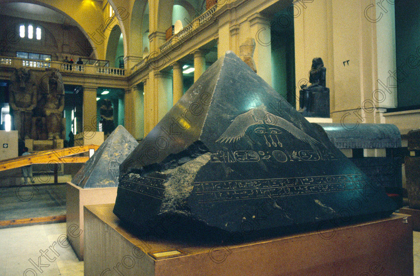 Pyramidion Amenemhat EG11812JHP 
 Egyptian Museum Cairo hall basalt polished pyramidion Pharaoh Amenemhat 111 from the top of his mudbrick pyramid at Hawara dating from around 1800 DC. In the prime antiquities collection in Cairo taken during visits between 1994 and 1996 when photography was allowed albeit without flash and tripod. None is of studio quality, being handheld with existing, usually extremely poor light and using slide film, pushed Fuji 400asa to get a suitable aperture and shutter speed. Most of the photos are from the Tutankahum exhibits while the rest are items that interested me as I explored this wonderful and extensive collection, requiring many more hours if not days and is only hinted at during the usual one or two hour visit made on a package tour. 
 Keywords: Egypt, Cairo, Egyptian, Museum, hall, collection, pyramidion, carved, hieroglypgs, eye, wings, solar, disk, cartouche, basalt, Amenemhat, pyramid, top, landscape, ancient, antiquity, antiquities, exhibit