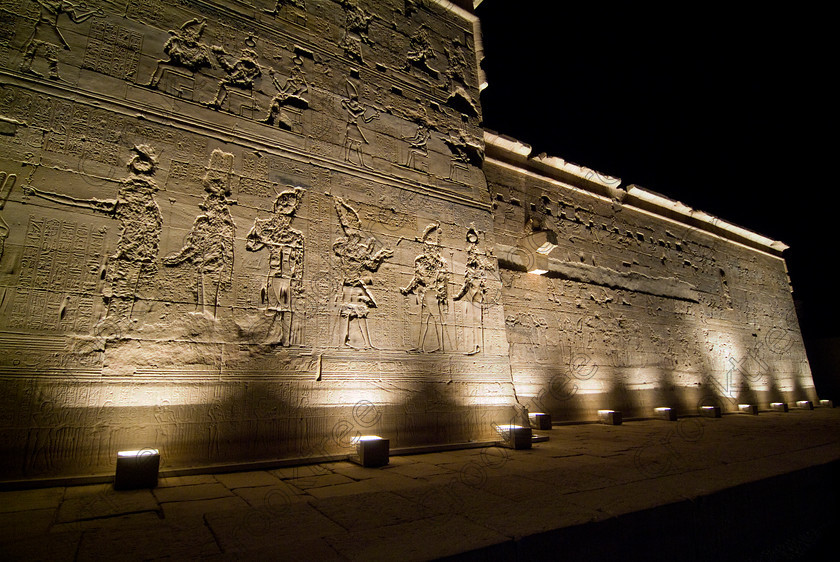 Philae Light Show EG052892JHP 
 Philae Temple Highlight Carvings Outer Walls Sound Light Show Aswan Egypt in which, during the first section, spectators walk through the temple with areas highlighted at each stop but the time to take photographs is limited. The second part of the evening is seated and photography is very easy, a tripod is permitted and necessary for time exposures to be made as flash on cameras is almost pointless and more of a nuisance for other viewers. This Sound & Light Show is perhaps the most spiritual of those shown at other centres especially with the trip at night by boat to the island and the peacefulness that naturally surrounds this location. 
 Keywords: Egypt, Egyptian, Aswan, River Nile, Agilkia Island, island, Philae, temple, light, sound, show, landscape, exterior, Gods, erased, damaged, hieroglyphs, Son, Lumiere, spectacular, fantasy, dramatic, night, dark, stars, colours, colors, colourful, colorful, spiritual, surreal
