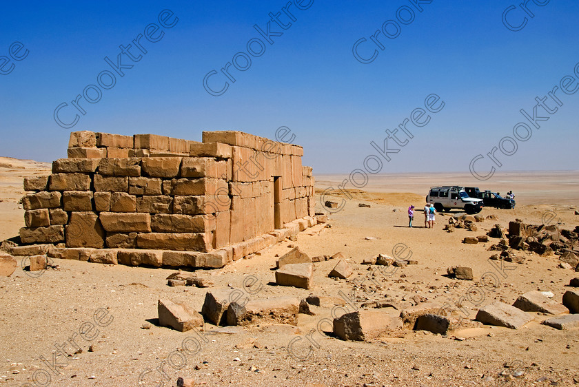Qasr al-Saghah & 4x4 6592EG07JHP 
 Qasr al-Saghah Temple Visitors Vehicles Egyptian Police Escort Desert Sand is the ruin of a small ancient Egyptian workers temple at Qasr al-Saghah near Lake Qarun and accessible only by 4x4 on specialist tours of Egypt 
 Keywords: Egypt, Egyptian, Egyptology, al-Siba, Qasr el-Sagha, al-Saghah, Es-Saghah, Temple, seven, cult, shrines, crypt, offering, table, room, Sobek, archaeology, ancient, history, landscape, 4x4, police, guards, desert, safari, calciferous, sandstone, sand, blistering, heat, sun, blue, sky, eroded, stones, foreground, hills, stratified, erosion