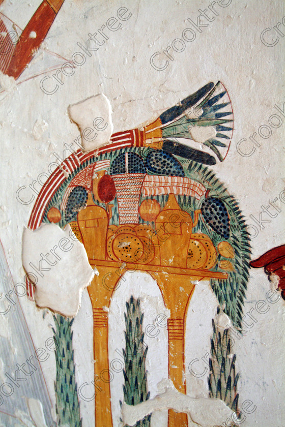 Valley Kings EG0213051jhp 
 Egyptian Tomb Valley kings Offering table fruit food lotus flowers painted colourful was son of Ramasses 1X, but his tomb was unfinished but has some excellent colourful depictions of the important ancient Egyptian Gods and although protected by Perspex panels, the custodian was very helpful and slid them back for me to take photographs in 2002 when it was still allowed. Thanks to the capability of the modern digital camera, the first and only chance I have had to use one, a Fuji S2 as photography is now banned in the Valley of Kings per se and especially in the tombs. Adjustments in Photoshop give the chance of reasonably accurate colours even when the tomb paintings were lit by low level artificial light when tripods and flash were not allowed; what could I get with a Nikon F700 and a tripod, which were allowed at one time as well. 
 Keywords: Egypt, Luxor, West Bank, Thebes, Theban, Valley Kings, prince, tomb, KV19, Montu, Mentuherkhepshef, Montu-hir-Khopshef, upright, paintings, colourful, colorful, colours, colors, bright, white, plaster, ancient, Egyptian, archaeology, Egyptology, hieroglyphs, death, burial, mythology, afterlife, history, hieroglyphics, Gods, offering, fruit, flowers, Lotus, table, wine, grapes, bread, DSLR, Fuji, S2, handheld, artificial, light, Photoshop, adjusted, corrections, Perspex, screens
