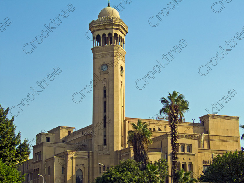 Cairo Mosque EG072639jhp 
 Egypt Cairo Kan al-Khalili area square Mosque tower clock palms is a busy and often important area as well as being a popular stop-off for tourists to Egypt and offered as part of City Tour where many bargains can be picked up as part of that exotic shopping experience in an Arabic Bazaar. Bargaining is also part of the fun and is expected throughout so a new and often daunting experience for the traditional conservative British visitor. Better value can probably be obtained in Aswan or Luxor and certainly for those doing a Nile Cruise large, weighty or fragile items are best left to the last minute. 
 Keywords: Egypt, Egyptians, Cairo, cruise Arabic, bargaining, tourism, tourists, landscape, capital, old, city, gates, Sultan, Qansuh, Fatimid, Kan al-Khalili, al-Kalili, souk, al-Badestan, maze, alleyways, alleys, shops, factories, bazaars, market, antiques, gold, jewellery, clothes, glass, leather, metal, wood, crafts, souvenirs, cafes, restaurants, sheeshas, trade, commercial, mosques, clock, tower, minaret, palm, trees, architecture, al-Azhar, Maydan, square, al-Hussein, Sayyidna, al-Husayn, building, 19C, Gothic
