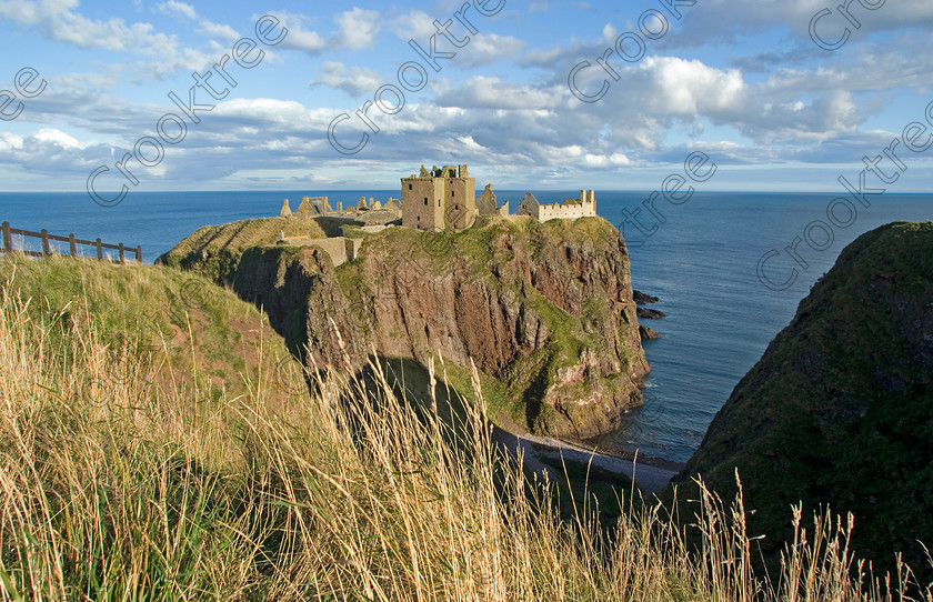 Dunnottar Castle Scotland VS2905JHP 
 Dunnottar Castle ruined Scottish fortress, viewed from the top of the cliffs near where the steps for easy access start bordered by the fence on the left edge of the photograph.
As a private property these photographs should only be used for tourist/scenic/editorial purposes. If required for commercial promotion then permission should be obtained from the owners by contacting The Factor; Dunecht Estates Office; Dunecht; Skene; AB32 7AX. Telephone: 01330 860223. 
 Keywords: Scotland, Scottish, Aberdeenshire, North, east, sea, Stonehaven, Kincardineshire, north, Dunnottar Castle, haven bay, castle, Dunnottar, Castle, landscape, spectacular, coast, coastal, cliffs, rocks, headland, bay, Haven, Benholm, Lodging, keep, tower, curtain, portcullis, vaulted, pends, arched, window, stonework, weathered, erosion, conglomerate, pudding, stone, Dun, Fother, 14th, century, Marischal, storehouse, smithy, bakery, brewery, stables, guardhouse, quadrangle, well, mansion, chambers, chapel, Whig's Vault, prison, dungeon, siege, Honours, jewels, Covenanters, exhibition, fortress’ ‘benholm lodging’, dun, fother, marischal, whig's vault