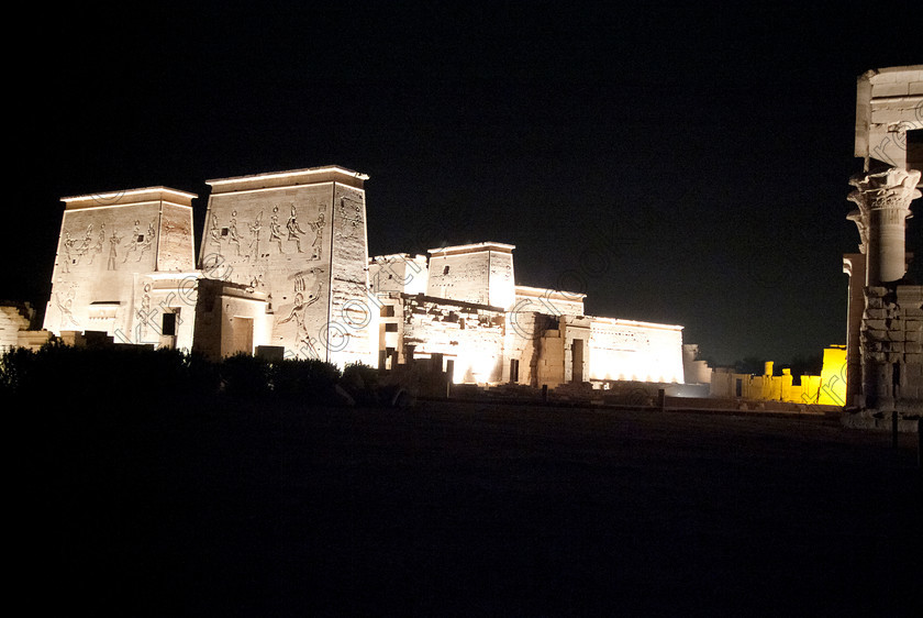 Philae Light Show EG052897JHP 
 Philae Temple Pylons Kiosk Vista Dark Night-time Light Show Aswan Egypt in which, during the first section, spectators walk through the temple with areas highlighted at each stop but the time to take photographs is limited. The second part of the evening is seated and photography is very easy, a tripod is permitted and necessary for time exposures to be made as flash on cameras is almost pointless and more of a nuisance for other viewers. This Sound & Light Show is perhaps the most spiritual of those shown at other centres especially with the trip at night by boat to the island and the peacefulness that naturally surrounds this location. 
 Keywords: Egypt, Egyptian, Aswan, River Nile, Agilkia Island, island, light, Philae, temple, sound, show, landscape, pylons, Trajan, kiosk, entrance, Son, Lumiere, spectacular, fantasy, dramatic, night, dark, stars, colours, colors, colourful, colorful, spiritual, surreal