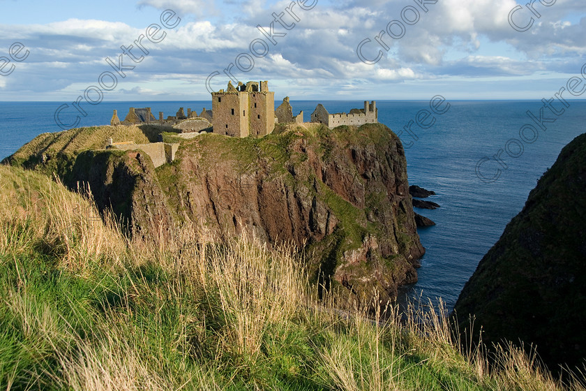 Dunnottar Castle Scotland VS2902JHP 
 Dunnottar Castle on the North East coast of Scotland near the town of Stonehaven viewed from the cliffs near the entrance steps that drop down these step and treacherous cliff-faces.
As a private property these photographs should only be used for tourist/scenic/editorial purposes. If required for commercial promotion then permission should be obtained from the owners by contacting The Factor; Dunecht Estates Office; Dunecht; Skene; AB32 7AX. Telephone: 01330 860223. 
 Keywords: Scotland, Scottish, Aberdeenshire, North, east, sea, Stonehaven, Kincardineshire, north, Dunnottar Castle, haven bay, castle, Dunnottar, Castle, landscape, spectacular, coast, coastal, cliffs, rocks, headland, bay, Haven, Benholm, Lodging, keep, tower, curtain, portcullis, vaulted, pends, arched, window, stonework, weathered, erosion, conglomerate, pudding, stone, Dun, Fother, 14th, century, Marischal, storehouse, smithy, bakery, brewery, stables, guardhouse, quadrangle, well, mansion, chambers, chapel, Whig's Vault, prison, dungeon, siege, Honours, jewels, Covenanters, exhibition, fortress’ ‘benholm lodging’, dun, fother, marischal, whig's vault