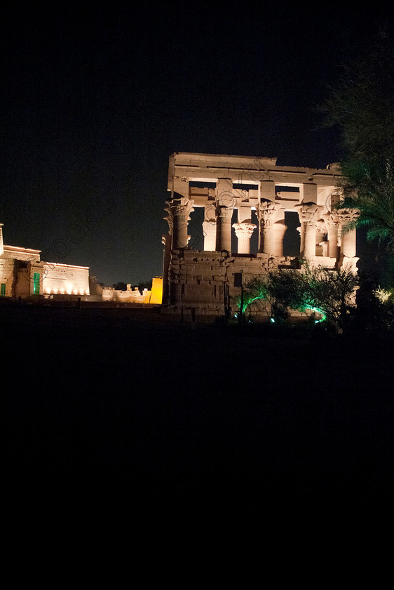 Philae Light Show EG052905JHP 
 Philae Temple Trajan Kiosk Sound Light Show Aswan Egypt Night-time Photo in which, during the first section, spectators walk through the temple with areas highlighted at each stop but the time to take photographs is limited. The second part of the evening is seated and photography is very easy, a tripod is permitted and necessary for time exposures to be made as flash on cameras is almost pointless and more of a nuisance for other viewers. This Sound & Light Show is perhaps the most spiritual of those shown at other centres especially with the trip at night by boat to the island and the peacefulness that naturally surrounds this location. 
 Keywords: Egypt, Egyptian, Aswan, River Nile, Agilkia Island, island, Philae, temple, light, sound, show, upright, Trajan, kiosk, Son, Lumiere, spectacular, fantasy, dramatic, night, dark, stars, colours, colors, colourful, colorful, spiritual, surreal