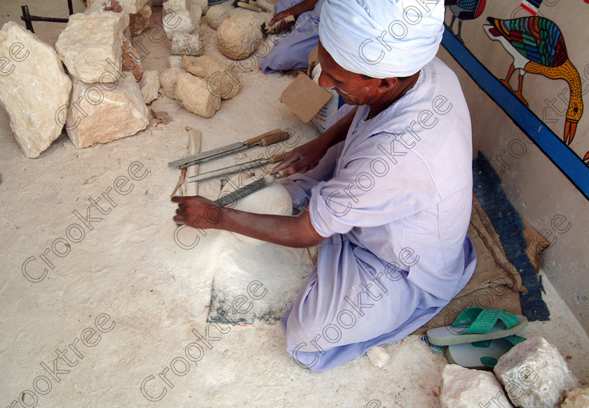 Luxor Alabaster Workers EG02096jhp 
 Egypt Egyptian Luxor Thebes Theban West Bank tourism alabaster factory workers traditional skills perhaps showing the many visitors to this part of ancient Egypt some of the techniques used by ancient Egyptians working alabaster crystal stone. These stops such as papyrus, perfumes, carpet making all give the visitor a chance to purchase souvenirs while no doubt imparting some idea of how the ancients did make the artefacts found in tombs. 
 Keywords: Egypt, Egyptian, Luxor, Thebes, Theban, West, Bank, Gurna, Qurna, Qurnah, Qurnat, MuraI, Shaykh, Abd al-Qurnah; Sheikh Abd, el-Qurna, alabaster, working, workers, techniques, skills, stone, factory, tourism, landscape