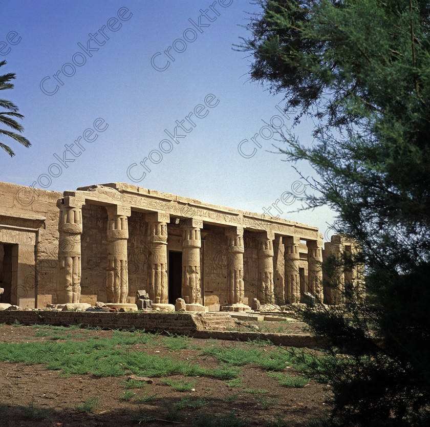 Seti 1 Luxor EG05145jhp 
 Temple Seti 1 Luxor Egypt exterior frontage tree framed portico 6x6 slide taken on the West Bank of the River Nile at Luxor in an area called al-Tarif turning off eastwards instead of taking the Valley of the Kings road. Attributed to Seti it had later involvement by Ramasses 1 and 11 and with recent restoration is a delightful extra addition should you have free time while in Luxor and described in the early days as Goorneh Temple. 
 Keywords: Egypt, Luxor, Thebes, River Nile, West Bank, Tarif, village, Temple, Sethos, Seti, Sety, Ramses, mortuary, Dra Abu el-Naga, Qurna, Goorneh, portico, vestibule, sun, court, landscape, interior, sandstone, wall, reliefs, bas, offering, Amun, Horus, Mut, desecration, damage, painted, hieroglyphs, cartouche, coloured, colours, colors, history, archaeology, ancient, Egyptian, Egyptology, open, air, museum, relics, stones, exterior, entrance, approach, decorated, barque, feast, offering, Amun, stele, Horus, Mut, bas, 2005, May, summer, 6x6, slide, film, Provia, RDP111, transparency 120, square, format, scanned, scan, camera, Yashica, Mat 124G