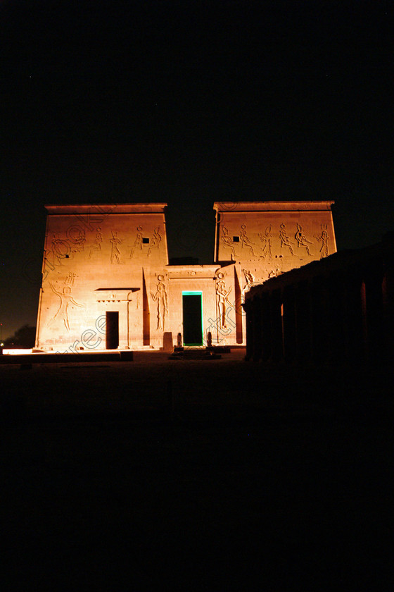 Aswan Philae Light Show EG02936jhp 
 Philae Temple Light Sound Show first pylon Aswan Egypt colours night in which, during the first section, spectators walk through the temple with areas highlighted at each stop but the time to take photographs is limited. The second part of the evening is seated and photography is very easy, a tripod is permitted and necessary for time exposures to be made as flash on cameras is almost pointless and more of a nuisance for other viewers. This Sound & Light Show is perhaps the most spiritual of those shown at other centres especially with the trip at night by boat to the island and the peacefulness that naturally surrounds this location. 
 Keywords: Egypt, Aswan, River, Nile, Nubia, Agilkia, Philae, Temple, upright, first, pylon, pylons, Trajan, Kiosk, stele, Ptolemaic, Island, Sound, Light, Son, Lumiere, surreal, experience, spectacular, fantasy, dramatic, colours, colors, colourful, colorful, history, antiquity, ancient, Egyptian, walk, through, sitting, dark, night, stars, holiday, travel, tourists, tourism, boat, water, Egyptology, entrance, courtyard, colonnade, 2002, Fuji, S2, DSLR
