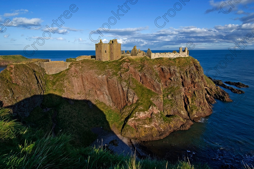 Dunnottar Castle Scotland VS2917JHP 
 Dunnottar Castle ruined Scottish fortress on a strategic rocky outcrop south of Stonehaven, viewed from the southern headland of Old Hall Bay reached by crossing over a step gorge called St Ninian's Den.
As a private property these photographs should only be used for tourist/scenic/editorial purposes. If required for commercial promotion then permission should be obtained from the owners by contacting The Factor; Dunecht Estates Office; Dunecht; Skene; AB32 7AX. Telephone: 01330 860223. 
 Keywords: Scotland, Scottish, Aberdeenshire, North, east, sea, Stonehaven, Kincardineshire, north, Dunnottar Castle, haven bay, castle, Dunnottar, Castle, landscape, spectacular, coast, coastal, cliffs, rocks, headland, bay, Haven, Benholm, Lodging, keep, tower, curtain, portcullis, vaulted, pends, arched, window, stonework, weathered, erosion, conglomerate, pudding, stone, Dun, Fother, 14th, century, Marischal, storehouse, smithy, bakery, brewery, stables, guardhouse, quadrangle, well, mansion, chambers, chapel, Whig's Vault, prison, dungeon, siege, Honours, jewels, Covenanters, exhibition, fortress’ ‘benholm lodging’, dun, fother, marischal, whig's vault