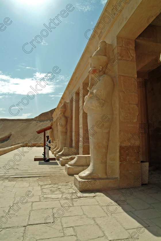 Hatshepsut Temple EG02108JHP 
 Hatshepsut Temple Upper central court terrace Queen Osiride statue policeman was opened again in 2002 and makes the visit to this magnificent temple almost complete except that entrance into the burial chamber itself is restricted. This magnificent mortuary temple is located on the West Bank of the River Nile at Luxor at an area called Deir el-Bahri and built into the base of the cliffs of the Theban Hill behind which are branches of the Valley of the Kings. 
 Keywords: Egypt, Luxor, Thebes, Theban, West Bank, Deir el-Bahri, el-Bahari, Dayr, Hatshepsut, mortuary, Temple, upright, upper, central, court, statues, archaeology, ancient, Egyptian, history, Egyptology, Consort, Queen, Pharaoh, Royal, ruler, woman, columns, hall