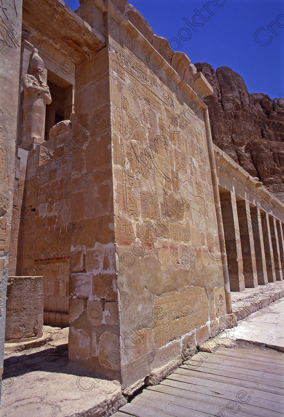 Hatshepsut Luxor EG206421jhp 
 Hatshepsut Hathor Chapel Osiride statue cliffs rockface Egyptian second terrace beneath the upper courtyard which was opened again in 2002 and makes the visit to this magnificent temple almost complete except that entrance into the burial chamber itself is restricted. This magnificent mortuary temple is located on the West Bank of the River Nile at Luxor at an area called Deir el-Bahri and built into the base of the cliffs of the Theban Hill behind which are branches of the Valley of the Kings.
Hatshepsut Temple decorations are still colourful and unlike most are accessible for photographing and lit by natural light. 
 Keywords: Egypt, Luxor, Thebes, Theban, West Bank, Deir el-Bahri, el-Bahari, Dayr, Hatshepsut, mortuary, Temple, second, colonnade, terraces, rock, cliffs, rockface, Hathor, Chapel, landscape, upright, archaeology, ancient, Egyptian, history, Egyptology, Consort, Queen, Pharaoh, Royal, ruler, woman, wall, painting, colourful, colorful, colours, colors, 2000, July, summer, 35mm, slide, film, Velvia, RVP, scanned, scan, camera, Nikon, FM2