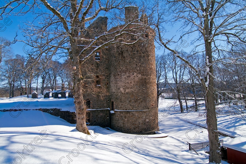 Huntly Tower Side TO173058JHP 
 Huntly Castle Winter Snow Tower White Sunny Trees Historic Scotland Aberdeenshire near River Deveron, the present manifestation being basically a Palace, is situated on a strategic hillock over looking the river near its joining the Bogie at the town of Huntly where traces of a motte and bailey stood dating back to the 12th century. The present ruin dates from the 15th century and is adorned with 17th century oriels and armorials. It was the family seat of the Gordon Earls of Huntly for much of its chequered history and major player in the history of Scotland from the days of Robert the Bruce to the troubles times of the Covenanters.
As this is a Historic Scotland property the photograph should be used for editorial, scenic or tourist related use. The castle carpark is a few yards from the entrance and ticket office and is accessed passing through the centre of Huntly and past the Gordon School. It is open for most of the summer and requires an entrance fee to be paid. 
 Keywords: Scotland, Scottish, Grampian, North East, Aberdeenshire, Huntly, Castle, fort, Palace, Historic, landscape, history, River Deveron, trees, winter, snow, tower