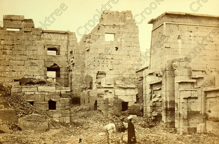 Frith Medinet Habu 8412VQJHP 
 Ancient Egyptian Temple Medinet Habu Original Main Gate Frith Photo Albumen Print at site on West Bank of River Nile at Luxor photographed by Francis Frith, an English Victorian photographer and probably around dated 1857. 
 Keywords: Egypt, Luxor, Thebes, River Nile, East Bank, Medinet Habu, entrance, landscape, gate, fortified, pylon, guide, donkey, ancient, history, archaeology, ancient, Egyptian, Egyptology, Francis Frith, English, Victorian, 1857, photographer, albumen, copy, print