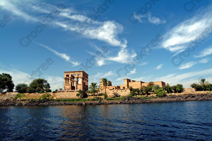 Philae Temple EG02550JHP 
 Philae Temple Panorama Motorboat Viewpoint Water Level Aswan Nile Egypt home of the Goddess Isis was established late in the history of Egypt being mainly Ptolemaic, eventually closing as a religious site around 550AD and being located on an island had remained remarkably untouched. Being relocated onto the Island of Agilkia on the River Nile near Aswan, to save it being flooded after the completion of the High Dam, it is perhaps one of the loveliest and most complete classic Egyptian temples to visit with a peaceful spirituality lacking in many of the land based sites. 
 Keywords: Egypt, Aswan, River Nile, Nubia, Philae Temple, island, pylons, landscape, temple, Ptolemaic, Trajan, Kiosk, history, ancient, Egyptian, antiquity, archaeology, Egyptology, Agilkia Island, motorboat, water, cirrus, clouds, blue, sky, dramatic