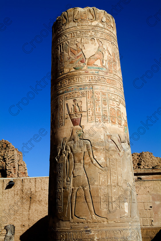 Kom Ombo Painted Column EG052458JHP 
 Kom Ombo Egyptian Ptolemy Temple Column Carved Painted Colours Atef Pschent Crown on the River Nile just north of Aswan and a regular visit on all Nile Cruises, was principally built by Ptolemy V of Silsilah sandstone. Dedicated to two Gods – Sobek, the crocodile and Horus, the falcon and although it has been damaged over the years, mainly through slipping into the River Nile and some structural damage owing to earthquakes, there are still some wonderful colourful reliefs of the most detailed and delicate style. 
 Keywords: Egypt, East Bank, River Nile, Kom Ombo, Temple, hypostyle hall, pylon, columns, bas reliefs, coloured, colored, colours, colors, Silsilah, sandstone, upright, history, archaeology, ancient, Egyptian, Egyptology, crocodiles, Ptolemaic, Ptolemy, Hathor, Isis, crown, Atef, cartouches, hieroglyphs, was, scepter, carvings, detailed, delicate, beautiful, fine