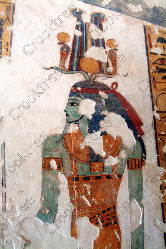 Valley Kings EG0213055jhp 
 Egypt Luxor Valley Tomb Mentuherkhepshef Osiris Atef Crown painting colours was son of Ramasses 1X, but his tomb was unfinished but has some excellent colourful depictions of the important ancient Egyptian Gods and although protected by Perspex panels, the custodian was very helpful and slid them back for me to take photographs in 2002 when it was still allowed. Thanks to the capability of the modern digital camera, the first and only chance I have had to use one, a Fuji S2 as photography is now banned in the Valley of Kings per se and especially in the tombs. Adjustments in Photoshop give the chance of reasonably accurate colours even when the tomb paintings were lit by low level artificial light when tripods and flash were not allowed; what could I get with a Nikon F700 and a tripod, which were allowed at one time as well. 
 Keywords: Egypt, Luxor, West Bank, Thebes, Theban, Valley Kings, prince, tomb, KV19, Montu, Mentuherkhepshef, Montu-hir-Khopshef, Osiris, Atef, crown, beard, upright, painting, painted, colourful, colorful, colours, colors, bright, white, plaster, ancient, Egyptian, archaeology, Egyptology, hieroglyphs, death, burial, mythology, afterlife, history, hieroglyphics, Gods, offering, fruit, flowers, wine, grapes, bread, DSLR, Fuji, S2, handheld, artificial, light, Photoshop, adjusted, corrections, Perspex, screens