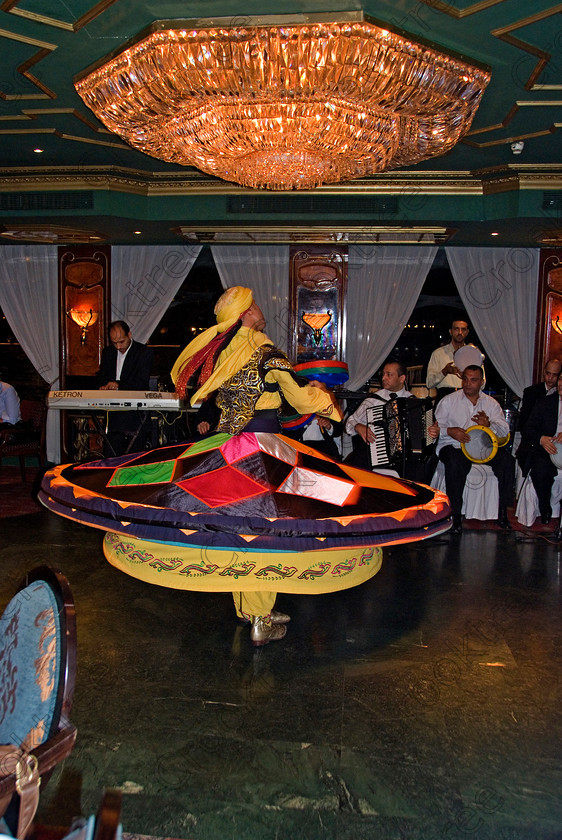 Cairo Cruiseboat Dancer 6995EG07JHP 
 Cairo Egypt Nile cruiseboat dancing show colourful ethnic entertaining additional tour on offer during a visit to city is an evening dinner with traditional music and dancing as entertainment on a River Nile cruiseboat cruising past the city lights and major riverside commercial buildings and offices. 
 Keywords: Egypt, Egyptian, River Nile, Cairo, holiday, cruiseboat, upright, entertainment, package, tourists, tourism, colours, colors, colourful, colorful, dancing, dinner, food, eating, clapping, music, musicians, spinning, dancer, man, Dervish, dress, blurred