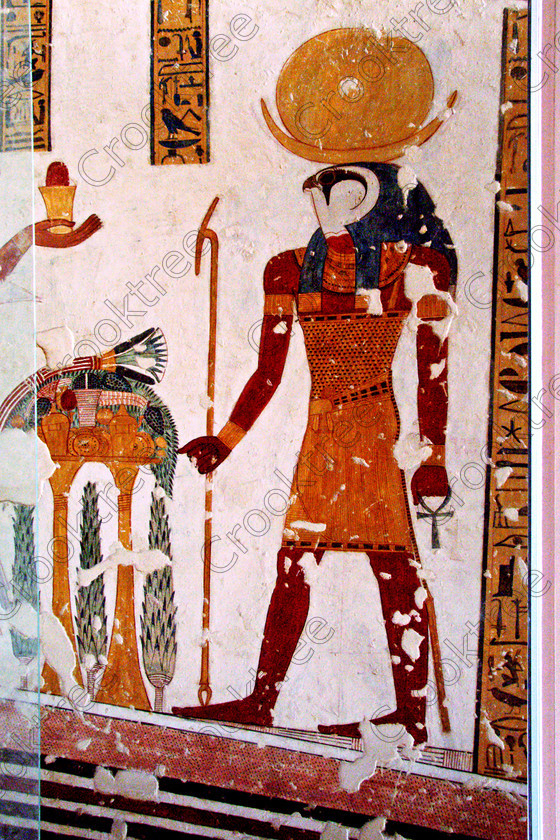 Valley Kings EG0213041jhp 
 Luxor Valley Kings Egyptian Tomb Mentuherkhepshef Khonsu falcon God painting colours was son of Ramasses 1X, although his tomb was unfinished it has some excellent colourful depictions of the important ancient Egyptian Gods and although protected by Perspex panels, the custodian was very helpful and slid them back for me to take photographs in 2002 when it was still allowed. Thanks to the capability of the modern digital camera, the first and only chance I have had to use one, a Fuji S2 as photography is now banned in the Valley of Kings per se and especially in the tombs. Adjustments in Photoshop give the chance of reasonably accurate colours even when the tomb paintings were lit by low level artificial light when tripods and flash were not allowed; what could I get with a Nikon F700 and a tripod, which were allowed at one time as well. 
 Keywords: Egypt, Luxor, West Bank, Thebes, Theban, Valley Kings, prince, tomb, KV19, Montu, Mentuherkhepshef, Montu-hir-Khopshef, Khonsu, Falcon, God, Horus, Solar, Disk, Crescent, upright, paintings, colourful, colorful, colours, colors, bright, white, plaster, ancient, Egyptian, archaeology, Egyptology, hieroglyphs, death, burial, mythology, afterlife, history, hieroglyphics, Gods, offering, fruit, flowers, wine, grapes, bread, DSLR, Fuji, S2, handheld, artificial, light, Photoshop, adjusted, corrections, Perspex, screens
