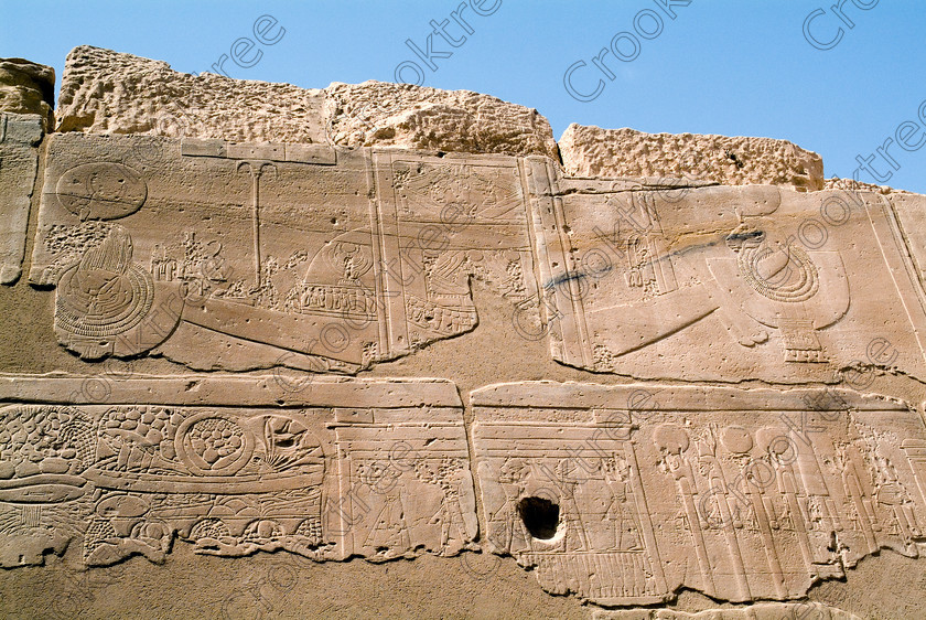 Seti 1 Temple EG053360JHP 
 Ancient Egyptian Temple Sety Wall Carving Barque Feast Offering Outside Light on the West Bank of the River Nile at Luxor in an area called al-Tarif turning off eastwards instead of taking the Valley of the Kings road. Attributed to Seti it had involvement by Ramasses 1 and 11 and with recent restoration is a delightful extra addition should you have free time while in Luxor and described in the early days as Goorneh Temple. 
 Keywords: Egypt, Luxor, Thebes, River Nile, West Bank, Tarif, village, Temple, Sethos, Seti, Sety, Ramses, mortuary, Dra Abu el-Naga, Qurna, Goorneh, landscape, barque, ram, aegis, sandstone, wall, reliefs, bas, food, fruit, history, archaeology, ancient, Egyptian, Egyptology, decorated