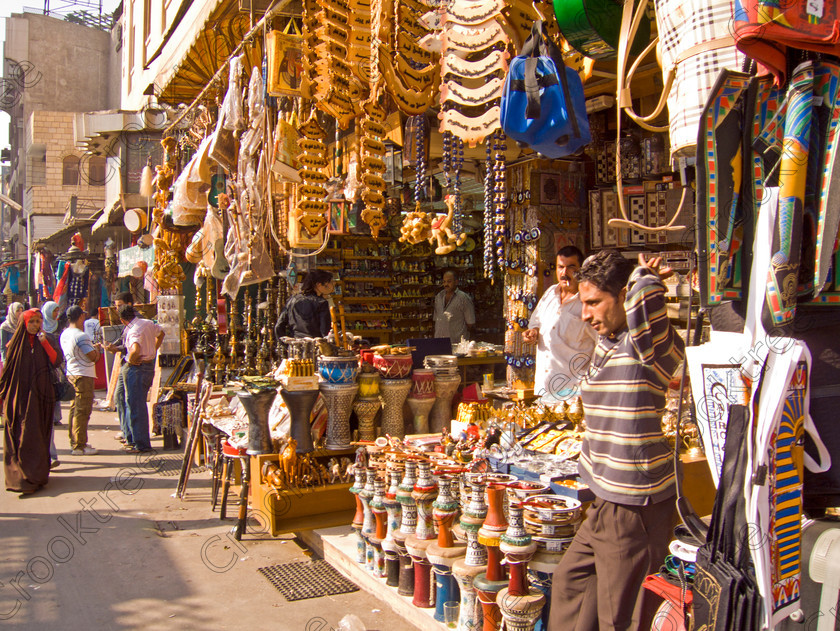 Cairo Khan al-Kalili EG072614jhp 
 Egypt Cairo Kan al-Kalili street shop Egyptians leather exotic colourful a busy and often important site seeing stop-off for tourists to Egypt and offered as part of City Tour where many bargains can be picked up as part of that exotic shopping experience in an Arabic Bazaar. Bargaining is also part of the fun and is expected throughout so a new and often daunting experience for the traditional conservative British visitor. Better value can probably be obtained in Aswan or Luxor and certainly for those doing a Nile Cruise large, weighty or fragile items are best left to the last minute. 
 Keywords: Egypt, Egyptians, Cairo, cruise Arabic, bargaining, tourism, tourists, landscape, capital, old, city, gates, Sultan, Qansuh, Fatimid, Kan al-Khalili, al-Kalili, souk, al-Badestan, maze, alleyways, alleys, shop, street, front, colourful, cluttered, factories, bazaars, market, antiques, gold, jewellery, clothes, glass, leather, metal, wood, crafts, souvenirs, cafes, restaurants, sheeshas, trade, commercial, mosques, minaret, palm, trees, architecture, al-Azhar, Maydan, square, al-Hussein, Sayyidna, al-Husayn, building, 19C, Gothic