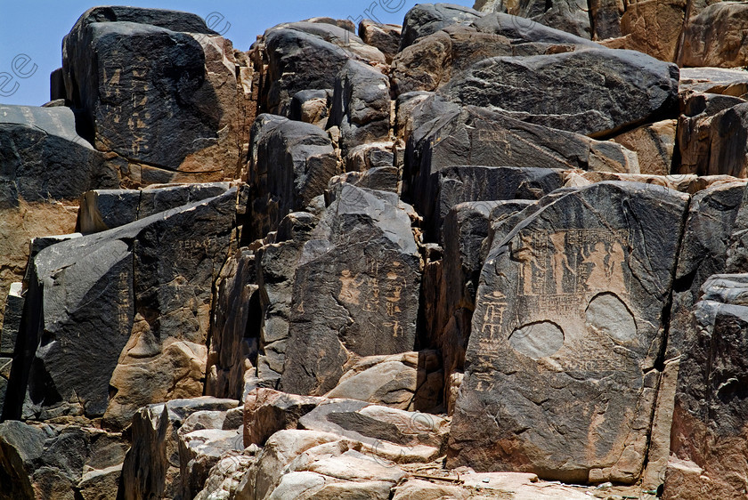 Seheil Rock carvings EG052664JHP 
 Seheil Island Rock Carvings Multiple Aswan River Nile cataracts boulders photo. The main reason for this private excursion by motorboat was to visit the rock carvings which cover this boulder strewn part of the Nile recording many events throughout the ancient history of the Egyptian Empire spanning some 3000 years although most were made in the 18-18 Dynasties. Most were the work of officials, often before they went to Nubia or reporting their efforts on return. The most notable carving is the Ptolemaic Famine Stele which refers to a famine during the reign of Doser, famous for the Step Pyramid at Saqqara, some 2000 years before. 
 Keywords: Egypt, Aswan, River Nile, Nubia, Nubian, Seheil Island, Sehel, rock, carvings, landscape, boulders, several, Gods, figures, history, archaeology, Egyptology, antiquity, Egyptian, ancient, officials, reports, projects