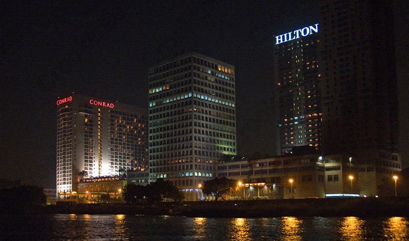 Cairo Nile at Night 7028EG07JHP 
 Cairo Egypt Nile cruise river night photo buildings Hilton lights water reflections on one of the special additional tours on offer during a visit to Cairo is an evening dinner with traditional music and dancing as entertainment on a River Nile cruiseboat cruising past the city lights and major riverside commercial buildings and offices. 
 Keywords: Egypt, Egyptian, River Nile, Cairo, holiday, cruiseboat, cruiseboats, water, sailing, night, waterfront, multistorey, skyscrapers, riverside, riverfront, offices, Conrad, Hilton, city, buildings, lights, landscape, entertainment, package, tourists, tourism, colours, colors, colourful, colorful