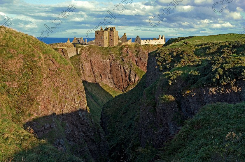 Dunnottar Castle Scotland VS2914JHP 
 Dunnottar Castle ruined Scottish fortress on a strategic rocky outcrop south of Stonehaven, viewed from the steep gorge called St Ninian's Den, and crossed over to view the castle from the southern headland of Old Hall Bay.
As a private property these photographs should only be used for tourist/scenic/editorial purposes. If required for commercial promotion then permission should be obtained from the owners by contacting The Factor; Dunecht Estates Office; Dunecht; Skene; AB32 7AX. Telephone: 01330 860223. 
 Keywords: Scotland, Scottish, Aberdeenshire, North, east, sea, Stonehaven, Kincardineshire, north, Dunnottar Castle, haven bay, castle, Dunnottar, Castle, landscape, spectacular, coast, coastal, cliffs, rocks, headland, bay, Haven, Benholm, Lodging, keep, tower, curtain, portcullis, vaulted, pends, arched, window, stonework, weathered, erosion, conglomerate, pudding, stone, Dun, Fother, 14th, century, Marischal, storehouse, smithy, bakery, brewery, stables, guardhouse, quadrangle, well, mansion, chambers, chapel, Whig's Vault, prison, dungeon, siege, Honours, jewels, Covenanters, exhibition, fortress’ ‘benholm lodging’, dun, fother, marischal, whig's vault