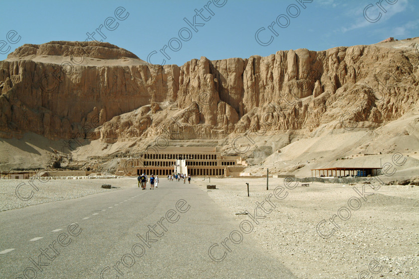 Hatshepsut Temple EG02142JHP 
 Hatshepsut Temple Entrance walk approach cliffs overhanging Luxor Egypt photograph Upper central court was opened again in 2002 and makes the visit to this magificent temple almost complete except that entrance into the burial chmaber itself is restricted, here with the whole temple viewed from the main approach. This magnificent mortuary temple is located on the West Bank of the River Nile at Luxor at an area called Deir el-Bahri and built into the base of the cliffs of the Theban Hill behind which are branches of the Valley of the Kings. 
 Keywords: Egypt, Luxor, Thebes, Theban, West Bank, Deir el-Bahri, el-Bahari, Dayr, Hatshepsut, mortuary, Temple, landscape, main, approach, vista, upper, central, court, statues, archaeology, ancient, Egyptian, history, Egyptology, Consort, Queen, Pharaoh, Royal, ruler, woman, columns, hall