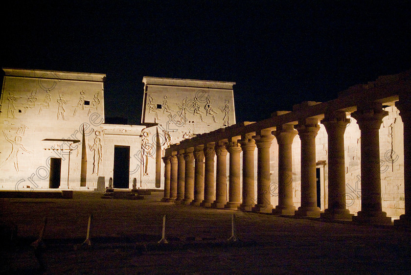 Philae Light Show EG052875JHP 
 Philae Temple Egypt Light Sound Show East Colonnade Pylon First Aswan Night in which, during the first section, spectators walk through the temple with areas highlighted at each stop but the time to take photographs is limited. The second part of the evening is seated and photography is very easy, a tripod is permitted and necessary for time exposures to be made as flash on cameras is almost pointless and more of a nuisance for other viewers. This Sound & Light Show is perhaps the most spiritual of those shown at other centres especially with the trip at night by boat to the island and the peacefulness that naturally surrounds this location. 
 Keywords: Egypt, Egyptian, Aswan, River Nile, Agilkia Island, island, Philae, Temple, light, sound, show, pylon, landscape, colonnade, eastern, temples, court, entrance, Son, Lumiere, spectacular, fantasy, dramatic, night, dark, stars, colours, colors, colourful, colorful, spiritual, surreal