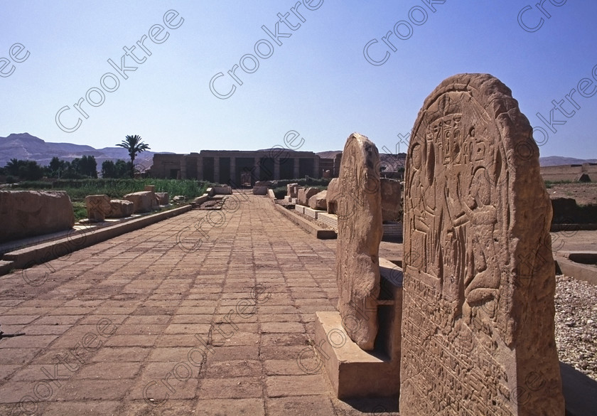 Seti 1 Luxor EG206430jhp 
 Goorneh Temple Seti Egypt Stele Pylon First Court Entrance Hypostyle Hall in the distance of this site on the West Bank of the River Nile at Luxor in an area called al-Tarif turning off eastwards instead of taking the Valley of the Kings road. Attributed to Seti it had involvement by Ramasses 1 and 11 and with recent restoration is a delightful extra addition should you have free time while in Luxor and described in the early days as Goorneh Temple. 
 Keywords: Egypt, Luxor, Thebes, River Nile, West Bank, Tarif, village, Temple, Sethos, Seti, Sety, Ramses, mortuary, Dra Abu el-Naga, Qurna, Goorneh, landscape, interior, sandstone, wall, reliefs, bas, offering, Amun, Horus, Mut, desecration, damage, painted, hieroglyphs, cartouche, coloured, colours, colors, history, archaeology, ancient, Egyptian, Egyptology, open, air, museum, relics, stones, exterior, entrance, approach, decorated, barque, feast, offering, Amun, stele, Horus, Mut, bas, 2000, July, summer, 35mm, slide, film, Velvia, RVP, scanned, scan, camera, Nikon, FM2