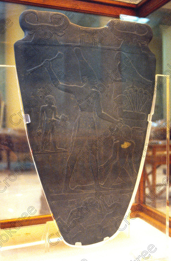Narmer Tablet EG11831JHP 
 Egyptian Cairo Museum Narmer Tablet Pharaoh Smiting Enemy interior photograph in the prime antiquities collection in Cairo taken during visits between 1994 and 1996 when photography was allowed albeit without flash and tripod. None is of studio quality, being handheld with existing, usually extremely poor light and using slide film, pushed Fuji 400asa to get a suitable aperture and shutter speed. Most of the photos are from the Tutankahum exhibits while the rest are items that interested me as I explored this wonderful and extensive collection, requiring many more hours if not days and is only hinted at during the usual one or two hour visit made on a package tour. 
 Keywords: Egypt, Cairo, Egyptian, Museum, narmer, Tablet, schist, Palette, king, warrior, conqueror, prisoner, war, club, victory, collection, upright, ancient, antiquity, antiquities, exhibit