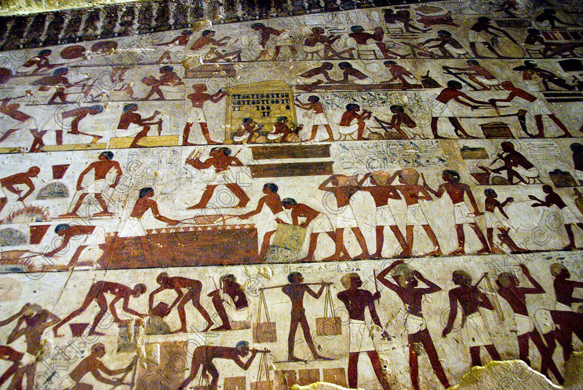 Rekhmire Tomb Painting EG075690JHP 
 Rekhmire Tomb Painting Luxor Egyptian Workers Tradesmen Carpenters Daily Life Scenes, one of many beautiful tomb decorations amongst the Tombs of the Nobles on the West Bank of the River Nile at Luxor. Rekhmire Tomb-Chapel [Tomb 100] was a Vizier during the reigns of Tuthmosis 11 and Amenhotep 11, part of a family with long service as administrators at Thebes. This highly decorated cruciform tomb is full images giving great understanding of Egyptian foreign policy, taxation and the justice system. The area around the Tombs has now been greatly improved with removal of many of the old modern houses and entry to these fascinating burial sites made more accessible. 
 Keywords: Egypt, Egyptian, ancient, Luxor, Tombs, Nobles, Thebes, River Nile, West Bank, Old Qurna, Sheikh Abd’el-Qurna, landscape, Rekhmire, Vizier, administrator, tomb, painting, workers, tradesmen, wood carving, metal, wood, working, shrine, gold, covering, craftsman, carrying, stones, colourful, colorful, colours, colors, painted, artificial, light, digital