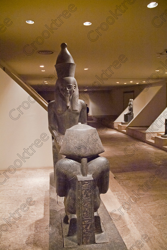 Luxor Cache Statues EG051958JHP 
 Egypt Egyptian Museum Photo Luxor Cache Cachette Interior Atum God was photographed inside this modern building on the waterfront of the River Nile with its fascinating collection covering the extensive history of ancient Egypt including items from the Tomb of Tutankahum. These particular exhibits are in an annex displaying statues discovered in 1989 in a storage pit and called The Luxor Temple Cachette of which the red quartzite life size statue of Amenhotep 111 is one of the finest pieces of carving yet found in Egypt. 
 Keywords: Egypt, Egyptian, Luxor, East, Bank, River, Nile, Museum, Cache, Cachette, Temple, Interior, Statues, upright, general, view, history, archaeology, Egyptology, exhibits, Atum, Mut, basalt, carved, figures, Gods, Goddess