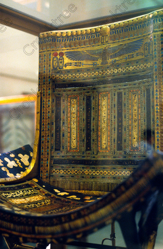 Tut Ceremonial Seat EG012613JHP 
 Egyptian Museum Cairo Tut Exhibit folding stool photograph with additional backrest from the Tomb of Tutakhamun and now in the prime antiquities collection in Cairo taken during visits between 1994 and 2001 when photography was allowed albeit without flash and tripod. None is of studio quality, being handheld with existing, usually extremely poor light and using slide film, pushed Fuji 400asa to get a suitable aperture and shutter speed. Most of the photos are from the Tutankahum exhibits while the rest are items that interested me as I explored this wonderful and extensive collection, requiring many more hours if not days and is only hinted at during the usual one or two hour visit made on a package tour. 
 Keywords: Egypt, Cairo, Egyptian, Museum, Tutankhamun, ceremonial, inlaid, seat, ebony, ivory, gold, leaf, glass, paste, semi-precious, stones, folding, stool, Tut, collection, upright, ancient, antiquity, antiquities, exhibit