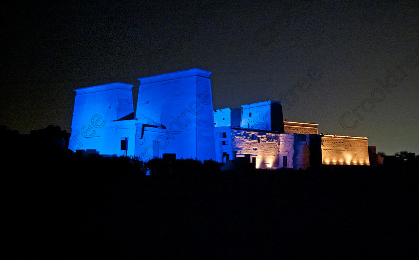 Philae Light Show EG052895JHP 
 Philae Temple Pylons Blue Light Sound Show Egypt River Nile Island Aswan in which, during the first section, spectators walk through the temple with areas highlighted at each stop but the time to take photographs is limited. The second part of the evening is seated and photography is very easy, a tripod is permitted and necessary for time exposures to be made as flash on cameras is almost pointless and more of a nuisance for other viewers. This Sound & Light Show is perhaps the most spiritual of those shown at other centres especially with the trip at night by boat to the island and the peacefulness that naturally surrounds this location. 
 Keywords: Egypt, Egyptian, Aswan, River Nile, Agilkia Island, island, Philae, temple, pylons, light, sound, show, landscape, colonnade, court, entrance, Son, Lumiere, spectacular, fantasy, dramatic, night, dark, stars, colours, colors, colourful, colorful, spiritual, surreal