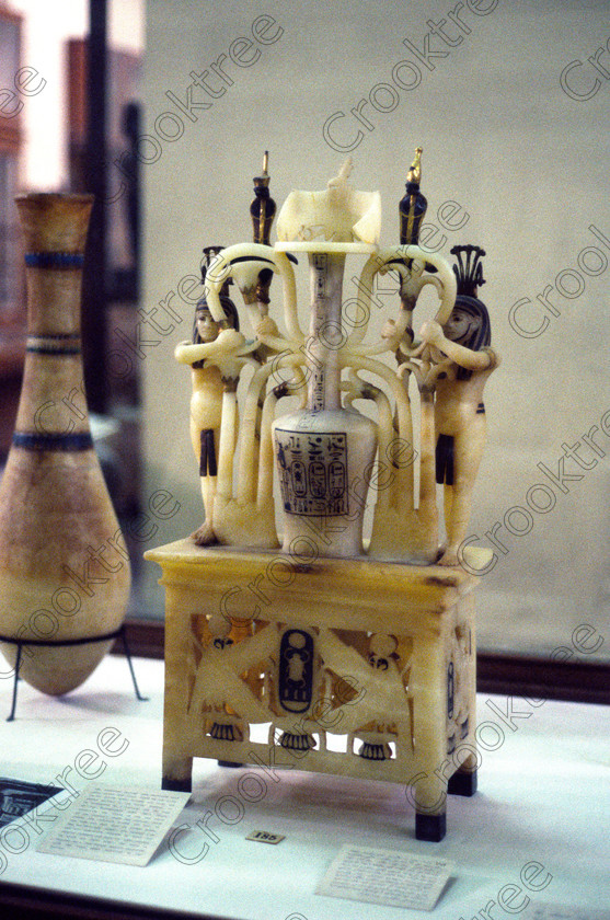 Tut Alabaster Container EG11712JHP 
 Egyptian Museum Cairo Exhibit alabaster perfume container Tutankhamun burial chamber in the prime antiquities collection in Cairo taken during visits between 1994 and 1996 when photography was allowed albeit without flash and tripod. None is of studio quality, being handheld with existing, usually extremely poor light and using slide film, pushed Fuji 400asa to get a suitable aperture and shutter speed. Most of the photos are from the Tutankahum exhibits while the rest are items that interested me as I explored this wonderful and extensive collection, requiring many more hours if not days and is only hinted at during the usual one or two hour visit made on a package tour. 
 Keywords: Egypt, Cairo, Egyptian, Museum, Tutankhamun, Tut, collection, alabaster, perfume, container, sema, union, cartouches, hieroglyphs, union, plants, knots, upright, ancient, antiquity, antiquities, exhibit