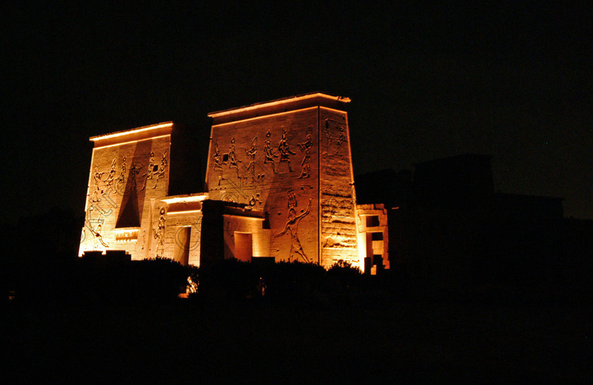 Aswan Philae Light Show EG02949jhp 
 Philae Temple Lumiere Son First Pylon Aswan Egypt colours lights night in which, during the first section, spectators walk through the temple with areas highlighted at each stop but the time to take photographs is limited. The second part of the evening as illustrated in this photo is seated and photography is very easy, a tripod is permitted and necessary for time exposures to be made as flash on cameras is almost pointless and more of a nuisance for other viewers. This Sound & Light Show is perhaps the most spiritual of those shown at other centres especially with the trip at night by boat to the island and the peacefulness that naturally surrounds this location. 
 Keywords: Egypt, Aswan, River, Nile, Nubia, Agilkia, Philae, Temple, landscape, first, pylon, Trajan, Kiosk, stele, Ptolemaic, Island, Sound, Light, Son, Lumiere, surreal, experience, spectacular, fantasy, dramatic, colours, colors, colourful, colorful, history, antiquity, ancient, Egyptian, walk, through, sitting, dark, night, stars, holiday, travel, tourists, tourism, boat, water, Egyptology, entrance, courtyard, colonnades, 2002, Fuji, S2, DSLR