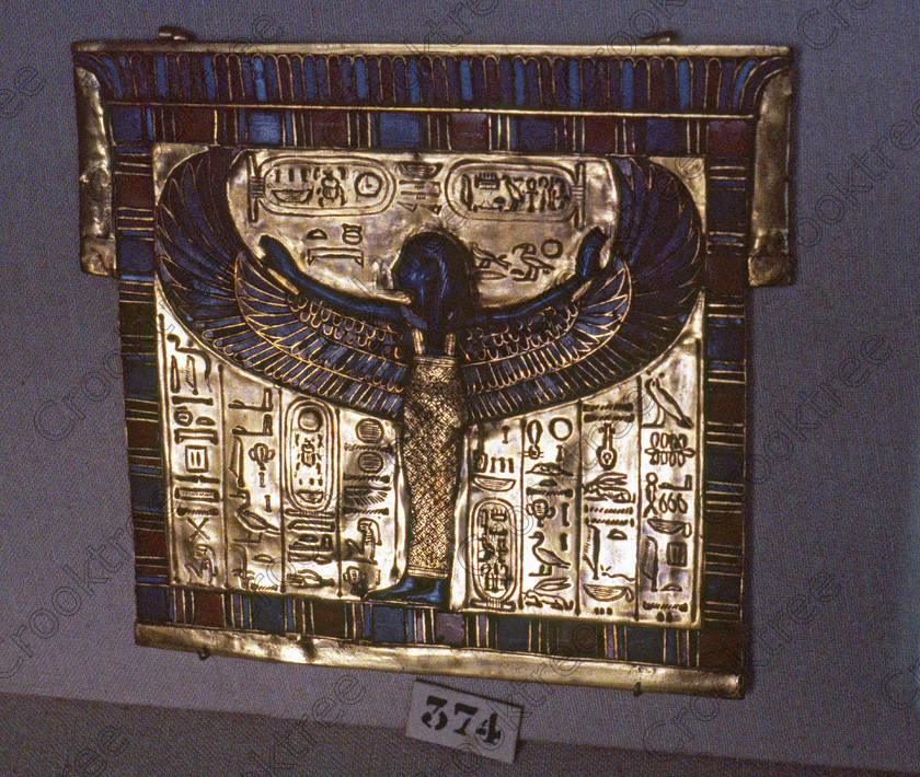 Tut Nut Plaque EG11736JHP 
 Egyptian Museum display pectoral Godess Nut Anubis shrine good, should be very gold looking and was shrine in the Tomb of Tutankhamun and is in the prime antiquities collection in Cairo taken during visits between 1994 and 1996 when photography was allowed albeit without flash and tripod. None is of studio quality, being handheld with existing, usually extremely poor light and using slide film, pushed Fuji 400asa to get a suitable aperture and shutter speed. Most of the photos are from the Tutankahum exhibits while the rest are items that interested me as I explored this wonderful and extensive collection, requiring many more hours if not days and is only hinted at during the usual one or two hour visit made on a package tour. 
 Keywords: Egypt, Cairo, Egyptian, Museum, Tutankhamun, pectorla, gold, Nut, Tut, collection, landscape, ancient, antiquity, antiquities, exhibit