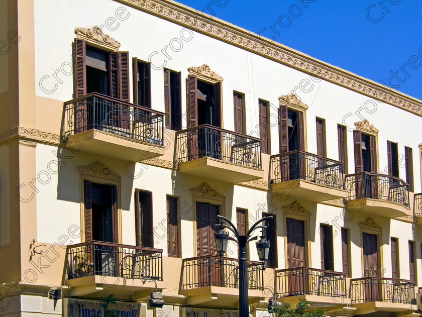 Luxor Street Architecture EG072598jhp 
 Egypt Luxor street residential apartments stylish Egyptian influence wadjet eye found along this long straight road Sharia al-Mahatta from just behind Luxor Temple and facing the elegant and modern railway station faade. We were dropped here before entering the station and boarding the main Aswan to Cairo train for a visit to the Minya area. One aspect of the traffic management that I thoroughly approved were the traffic lights at junctions with a clock showing how soon to the change of lights. 
 Keywords: Egypt, Thebes, Luxor, Waset, Ipetisut, East, Bank, River, Nile, Sharia, al Mahatta, landscape, road, station, platform, train, railway, Ramses, waterfront, promenade, esplanade, Corniche, modern, architecture, European, influence, style, stylish, balconies, Egyptian, theme, eye, wedjat, freize, cornice, construction, apartment, block, street, cars, people, tree-lined