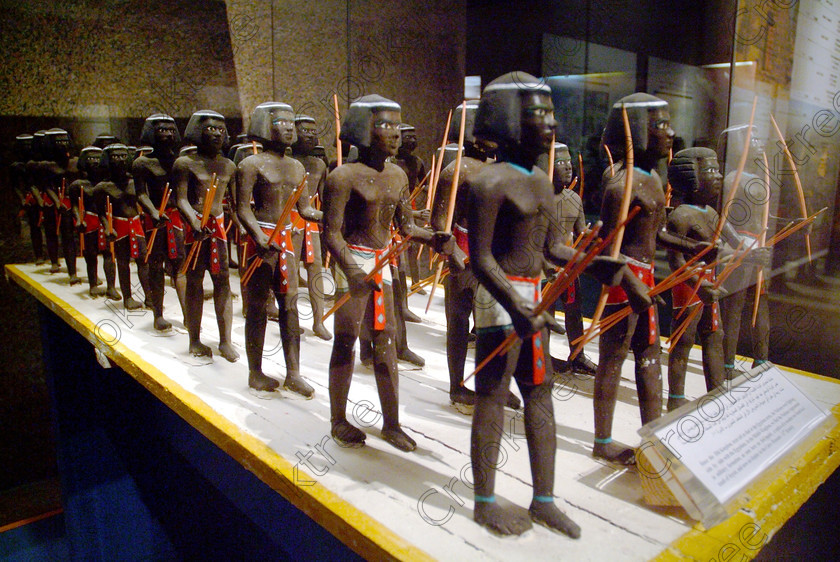 Aswan Museum Model Soldiers EG052939JHP 
 Aswan Egyptian Nubian Museum exhibit of model wooden soldiers from the 11th Dynasty of the Old Kingdom inside a modern air-conditioned building whose foundations were laid in 1986, opened in 1997 and organised through UNESCO. Very low artificial light makes general photography difficult as well as affecting accurate colour balance. This now appears to be the only museum in Egypt where photography is still allowed although it is not easy as the ambient lighting is extremely subdued for conservation reasons. 
 Keywords: Egypt, Egyptian, Aswan, Nubian, Nubia, Museum, exhibit, inside, interior, ancient, prehistoric, Islamic, Mameluke, landscape, model, soldiers, wooden, archers, bows, arrows