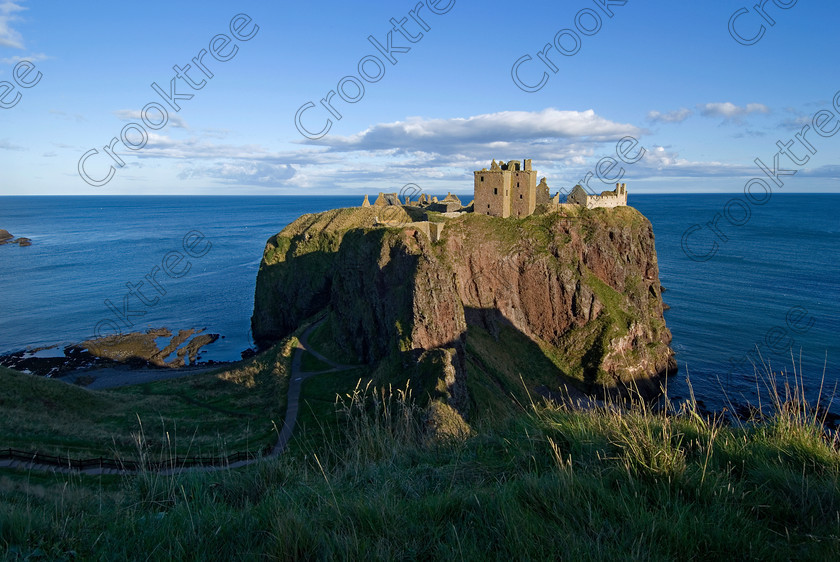 Dunnottar Castle Scotland VS2938JHP 
 Dunnottar Castle ruined Scottish fortress on a strategic rocky outcrop south of Stonehaven, viewed from the top of the cliffs at the beginning of the steps down the cliff-face, the lower section of which can be seen bottom left.
As a private property these photographs should only be used for tourist/scenic/editorial purposes. If required for commercial promotion then permission should be obtained from the owners by contacting The Factor; Dunecht Estates Office; Dunecht; Skene; AB32 7AX. Telephone: 01330 860223. 
 Keywords: Scotland, Scottish, Aberdeenshire, North, east, sea, Stonehaven, Kincardineshire, north, Dunnottar Castle, haven bay, castle, Dunnottar, Castle, landscape, spectacular, coast, coastal, cliffs, rocks, headland, bay, Haven, Benholm, Lodging, keep, tower, curtain, portcullis, vaulted, pends, arched, window, stonework, weathered, erosion, conglomerate, pudding, stone, Dun, Fother, 14th, century, Marischal, storehouse, smithy, bakery, brewery, stables, guardhouse, quadrangle, well, mansion, chambers, chapel, Whig's Vault, prison, dungeon, siege, Honours, jewels, Covenanters, exhibition, fortress’ ‘benholm lodging’, dun, fother, marischal, whig's vault