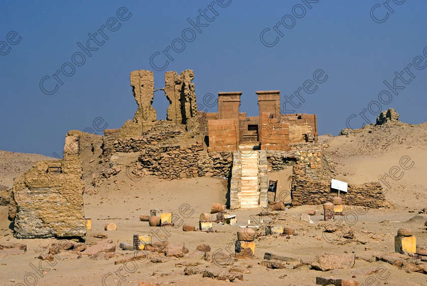 Karanis North Temple 6462EG07JHP 
 Karanis Kom Aushim Ruins North Temple Egyptian Desert Fayoum Photo was a city on the north eastern edge of the area known as Fayoum and dates from Ptolemaic times through to 500AD. Two Roman dated temples survive in reasonable state, the northern one in this photo and the southern one is dedicated to the crocodile Gods of Pnepheros and Petesuchos. Many finds have been made especially of life in a residential area with houses scattered throughout the site and there is also a fine Roman bathhouse. A small museum now closed has ben replaced with an open air area with a selection of artefacts adjacent to the main walk to the temples. 
 Keywords: Egypt, Egyptian, Egyptology, landscape, Karanis, Kom Aushim, el-Fayoum, Faiyum, Fayyum, Nero, Claudius, Vespasiun, Roman Emperors, North temple, stairs, gleaming, shining, surreal, desert, sand