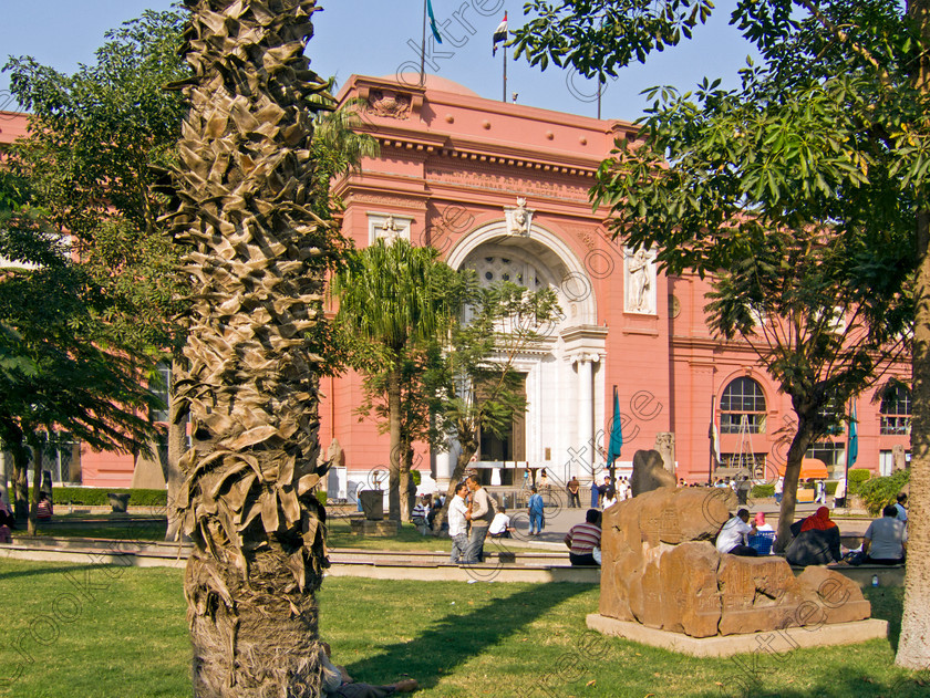 Cairo Egyptian Museum EG072608jhp 
 Egyptian Museum entrance Cairo Egypt trees palms seats exhibits Mariette founder is the prime antiquities collection in Cairo and of ancient Egypt in the world. These photos were taken through the roadside railings as cameras were banned then and that probably applies today as well. Unlike the British Museum in London where photography is allowed and even flash can be used, the Egyptian Museum and many others throughout the country have a total ban on photography and the reason being probably more to do with managing the huge crowds than one would hope is not to do with selfishness or the usual damaged caused by flash syndrome, a total red herring if ever there was one. 
 Keywords: Egypt, Cairo, Egyptian, Museum, Mariette, Maspero, landscape, collection, huge, comprehensive, discovery, excavations, ancient, antiquity, antiquities, archaeology, architecture, iconic, exhibits, pond, feature, entrance, sphinx, seats, photography, ban, no cameras, flagpoles, capital, city