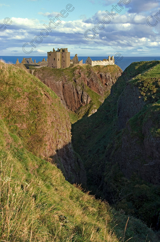 Dunnottar Castle Scotland VS2912JHP 
 Dunnottar Castle ruined Scottish fortress on a strategic rocky outcrop south of Stonehaven, viewed from the steep gorge called St Ninian's Den, and crossed over to view the castle from the southern headland of Old Hall Bay.
As a private property these photographs should only be used for tourist/scenic/editorial purposes. If required for commercial promotion then permission should be obtained from the owners by contacting The Factor; Dunecht Estates Office; Dunecht; Skene; AB32 7AX. Telephone: 01330 860223. 
 Keywords: Scotland, Scottish, Aberdeenshire, North, east, sea, Stonehaven, Kincardineshire, north, Dunnottar Castle, haven bay, castle, Dunnottar, Castle, upright, spectacular, coast, coastal, cliffs, rocks, headland, bay, Haven, Benholm, Lodging, keep, tower, curtain, portcullis, vaulted, pends, arched, window, stonework, weathered, erosion, conglomerate, pudding, stone, Dun, Fother, 14th, century, Marischal, storehouse, smithy, bakery, brewery, stables, guardhouse, quadrangle, well, mansion, chambers, chapel, Whig's Vault, prison, dungeon, siege, Honours, jewels, Covenanters, exhibition, fortress’ ‘benholm lodging’, dun, fother, marischal, whig's vault