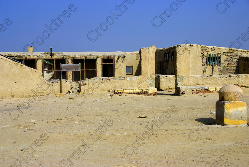 Karanis Old British Army HQ 6427EG07JHP 
 Karanis Kom Aushim British Army HQ Desert Base Egypt Derelict was an ancient city on the north eastern edge of the area known as Fayoum and dates from Ptolemaic times through to 500AD. Two Roman dated temples survive in reasonable state and the southern one is dedicated to the crocodile Gods of Pnepheros and Petesuchos. Many finds have been made especially of life in a residential area with houses scattered throughout the site and there is also a fine Roman bathhouse. A small museum now closed has been replaced with an open air area with a selection of artefacts adjacent to the main walk to the temples and illustrated in this photo is th remains of an old WW2 British army HQ. 
 Keywords: Egypt, Egyptian, Egyptology, ancient, landscape, Karanis, Kom Aushim, British, military, army, HQ, base, camp, el-Fayoum, Faiyum, Fayyum, Lake Qarun, Moeris, sand, desert