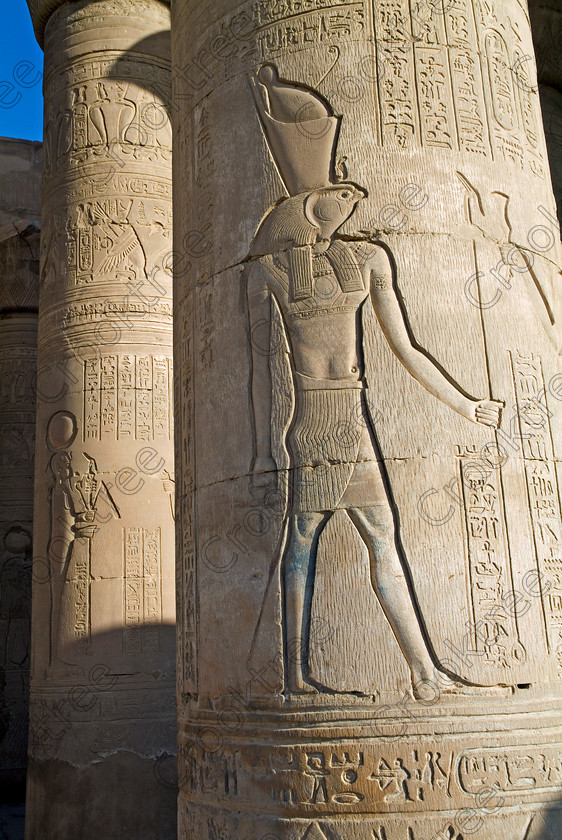 Kom Ombo Horus EG052494JHP 
 Kom Ombo Ptolemaic Temple Egypt Horus Was Scepter Pschent Carving Column on the River Nile just north of Aswan and a regular visit on all Nile Cruises, was principally built by Ptolemy V of Silsilah sandstone. Dedicated to two Gods – Sobek, the crocodile and Horus, the falcon and although it has been damaged over the years, mainly through slipping into the River Nile and some structural damage owing to earthquakes, there are still some wonderful colourful reliefs of the most detailed and delicate style. 
 Keywords: Egypt, East Bank, River Nile, Kom Ombo, Temple, hypostyle hall, pylon, columns, bas reliefs, coloured, colored, colours, colors, Silsilah, sandstone, landscape, upright, history, archaeology, ancient, Egyptian, Egyptology, crocodiles, Ptolemaic, Ptolemy, Horus, Haroeris, Harwer, Sobek, Hathor, carvings, detailed, delicate, beautiful, fine