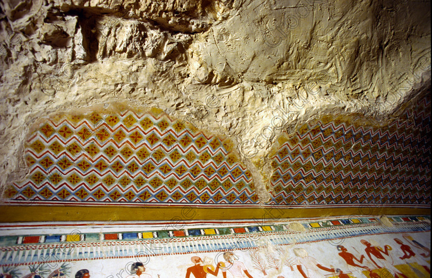Menna Tomb Ceiling EG10022JHP 
 Luxor Egypt Menna Tomb Nobles Ceiling Matting Colours Patterned Photo is one of many beautiful tomb decorations amongst the Tombs of the Nobles on the West Bank of the River Nile at Luxor. The Menna Tomb-Chapel is cruciform in design located in the Upper Enclosure [Tomb 69] was a Scribe of the Royal Fields during the reign of Thutmosis 1V around 1400BC. This was one of the first Tomb of the Nobles I visited in 1994 and was taken by the colourful painted reliefs, difficult to photograph as protected by Perspex sheeting and only lit by reflected light done by the custodians. The area around the Tombs has now been greatly improved with removal of many of the old modern houses and entry to these fascinating burial sites made more accessible. 
 Keywords: Egypt, Egyptian, ancient, Luxor, Tombs, Nobles, Thebes, River Nile, West Bank, Old Qurna, Sheikh Abd’el-Qurna, landscape, Menna, scribe, ceiling, patterns, matting, bright, tomb, painting, colourful, colorful, colours, colors, painted, sun, reflected, light, transparency, scanned